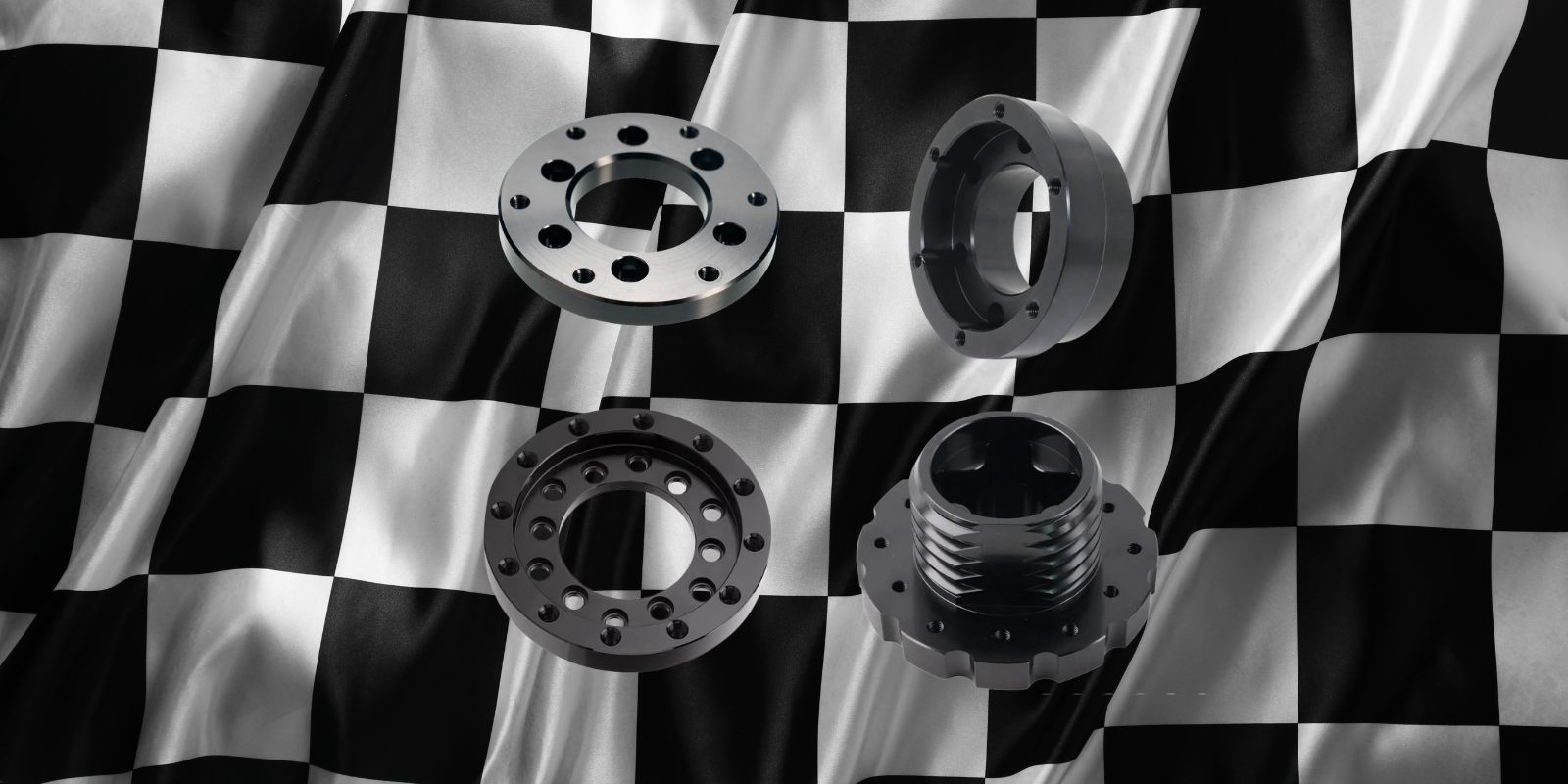 Metallic sim racing wheel adapters on checkered flag - IGNI RACING