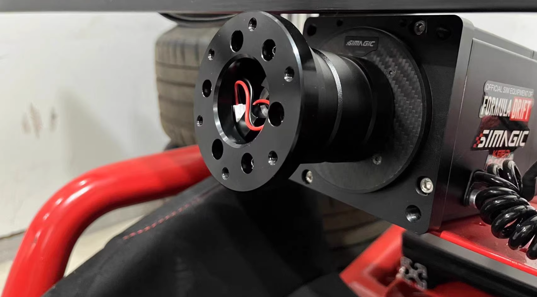 Simagic Formula Drift sim racing equipment with black wheel adapter mounted