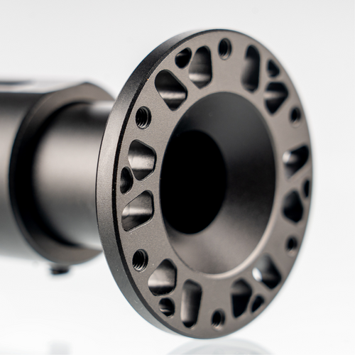 Close-up of adjustable shaft extension's perforated metal end with mounting holes