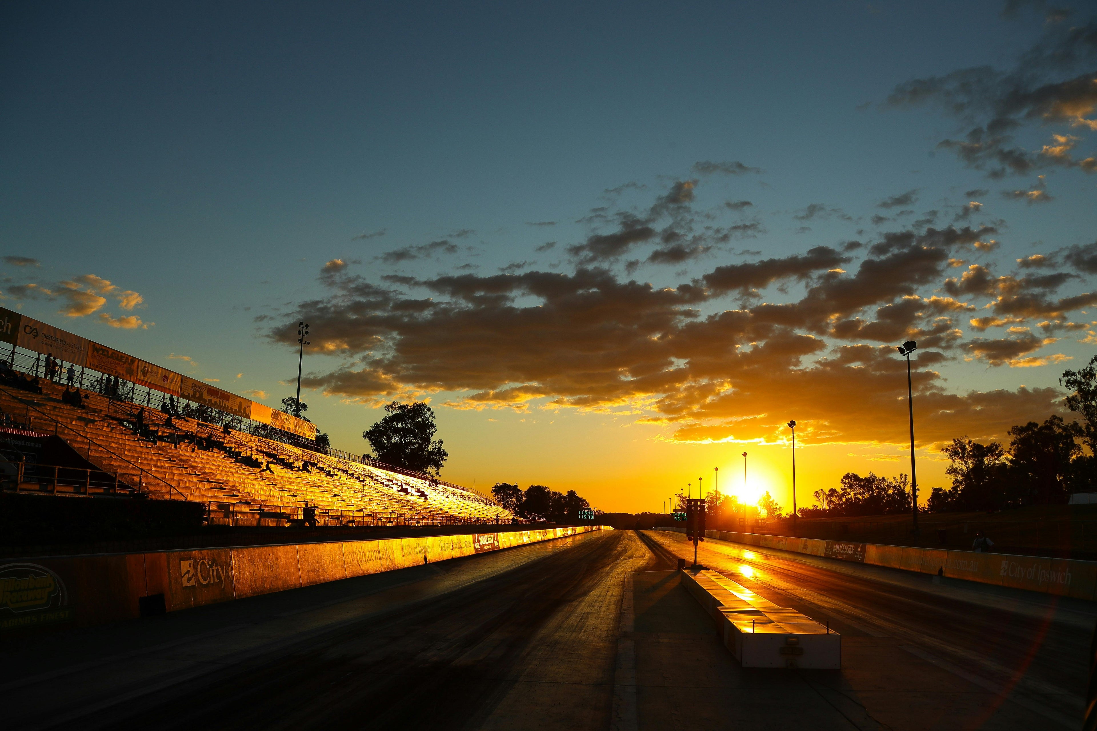 Sunset over a race track with empty grandstands