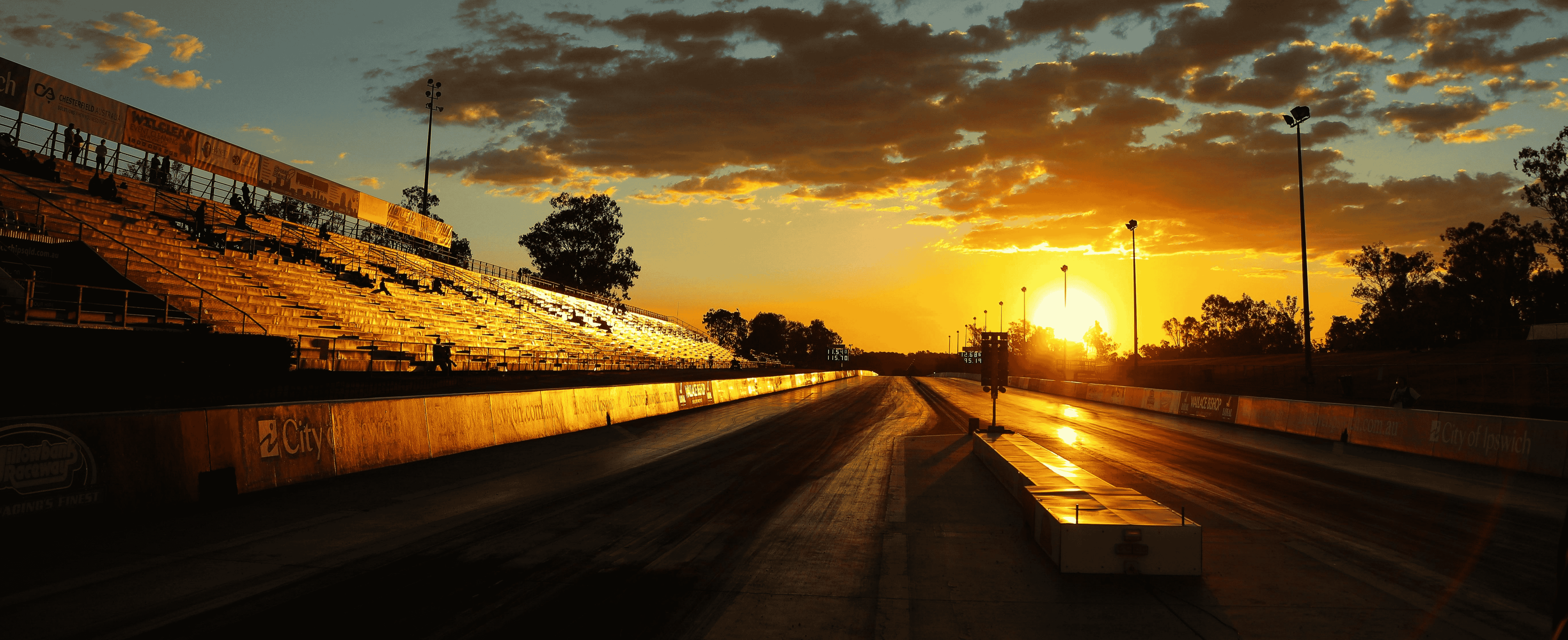 Sunset over a race track with empty grandstands