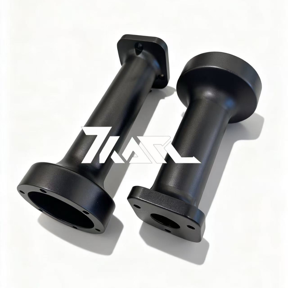 Two matte black metal KARL Extenders for Simucube 3, featuring square and rounded mounting bases.