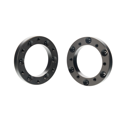 Black circular extension adapters for Simagic Alpha EVO sim racing setup