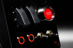 Sim racing button box with red Engine Start button, carbon fiber switches, and illuminated controls